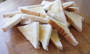 Preparing bread for bread butter pudding - Pikalily food blog